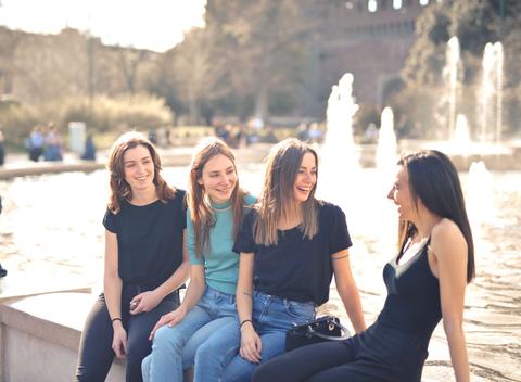 western group of friends laughing outdoors